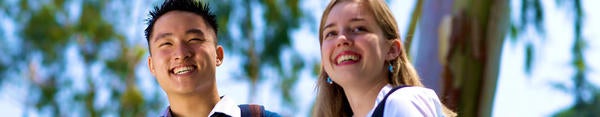 Two UCR students smile as they enjoy a sunny SoCal day at UC Riverside